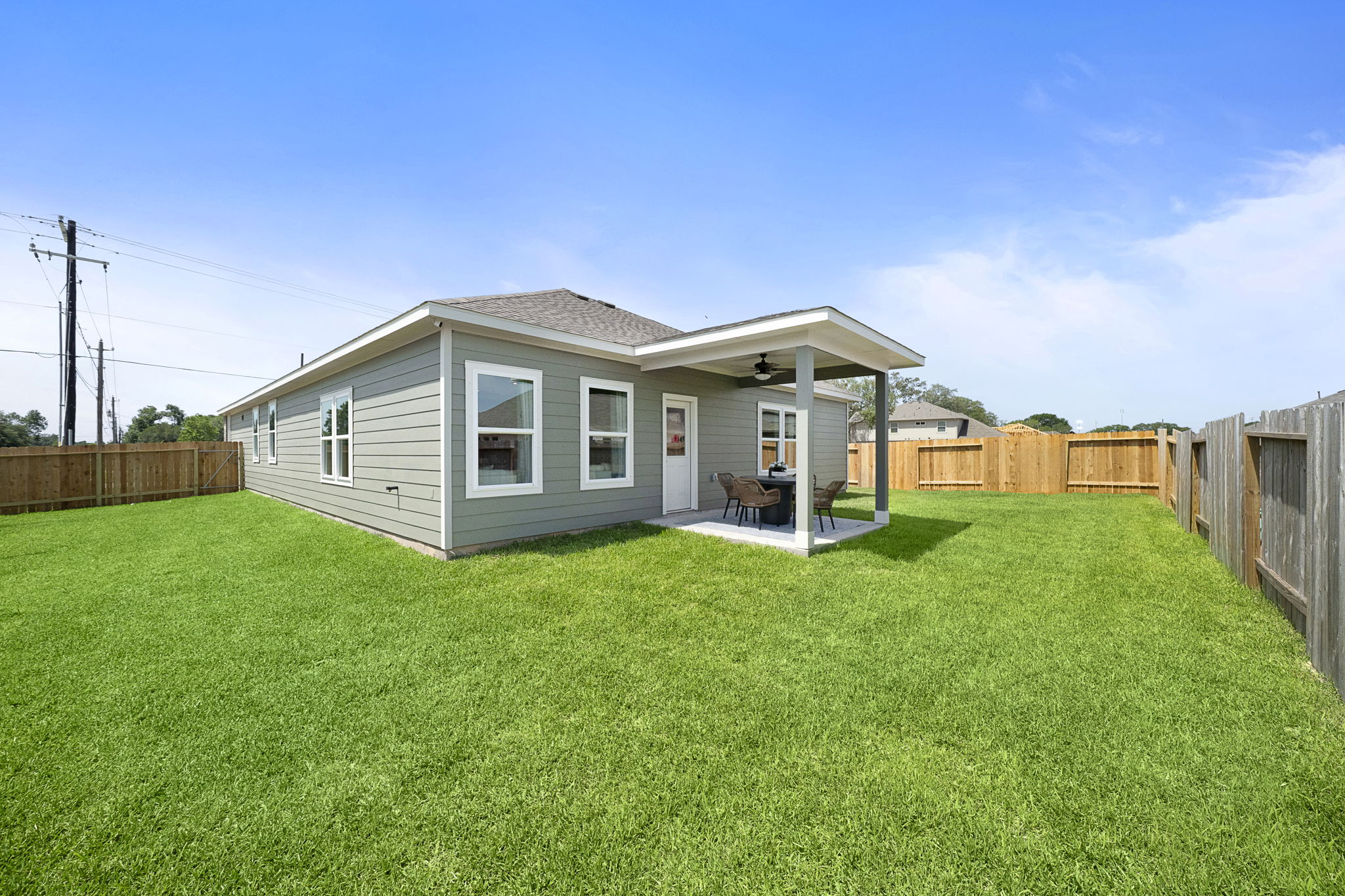 A house with a fence and grass.