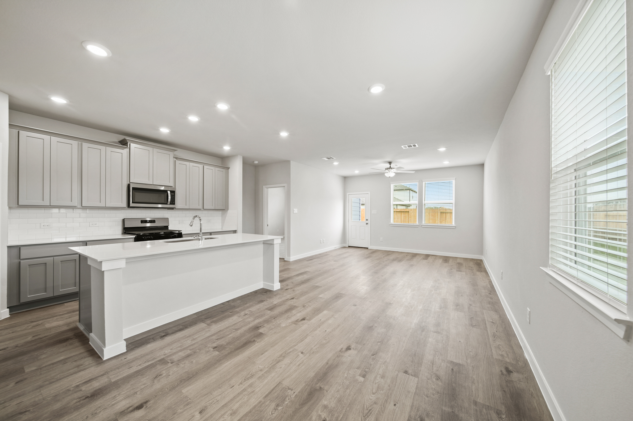 A kitchen with white cabinets.