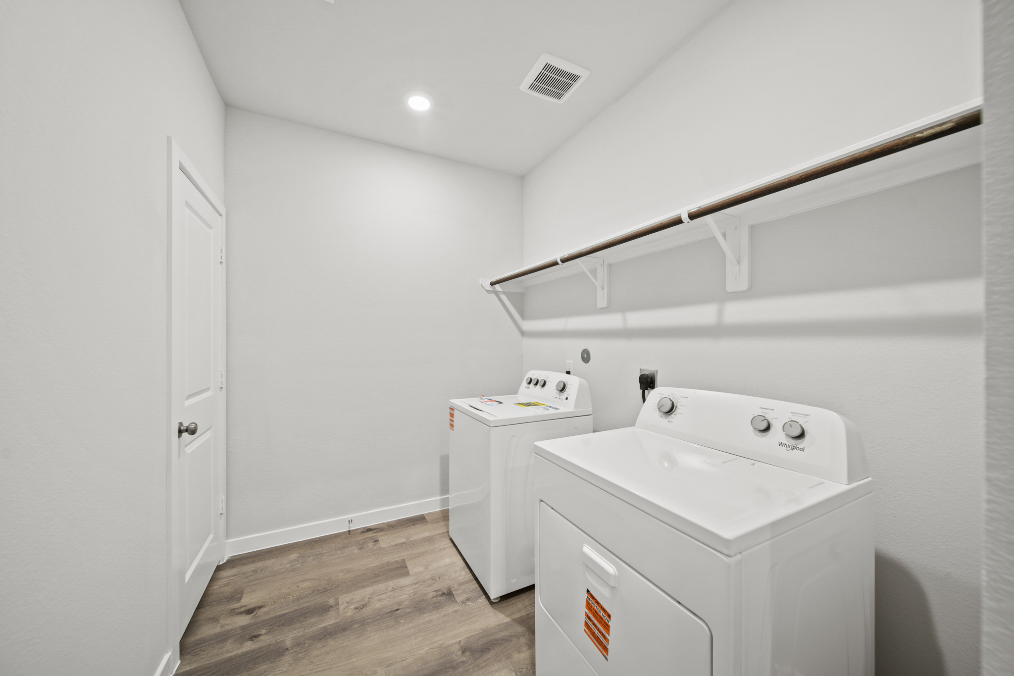 A white bathroom with a sink and a white cabinet.