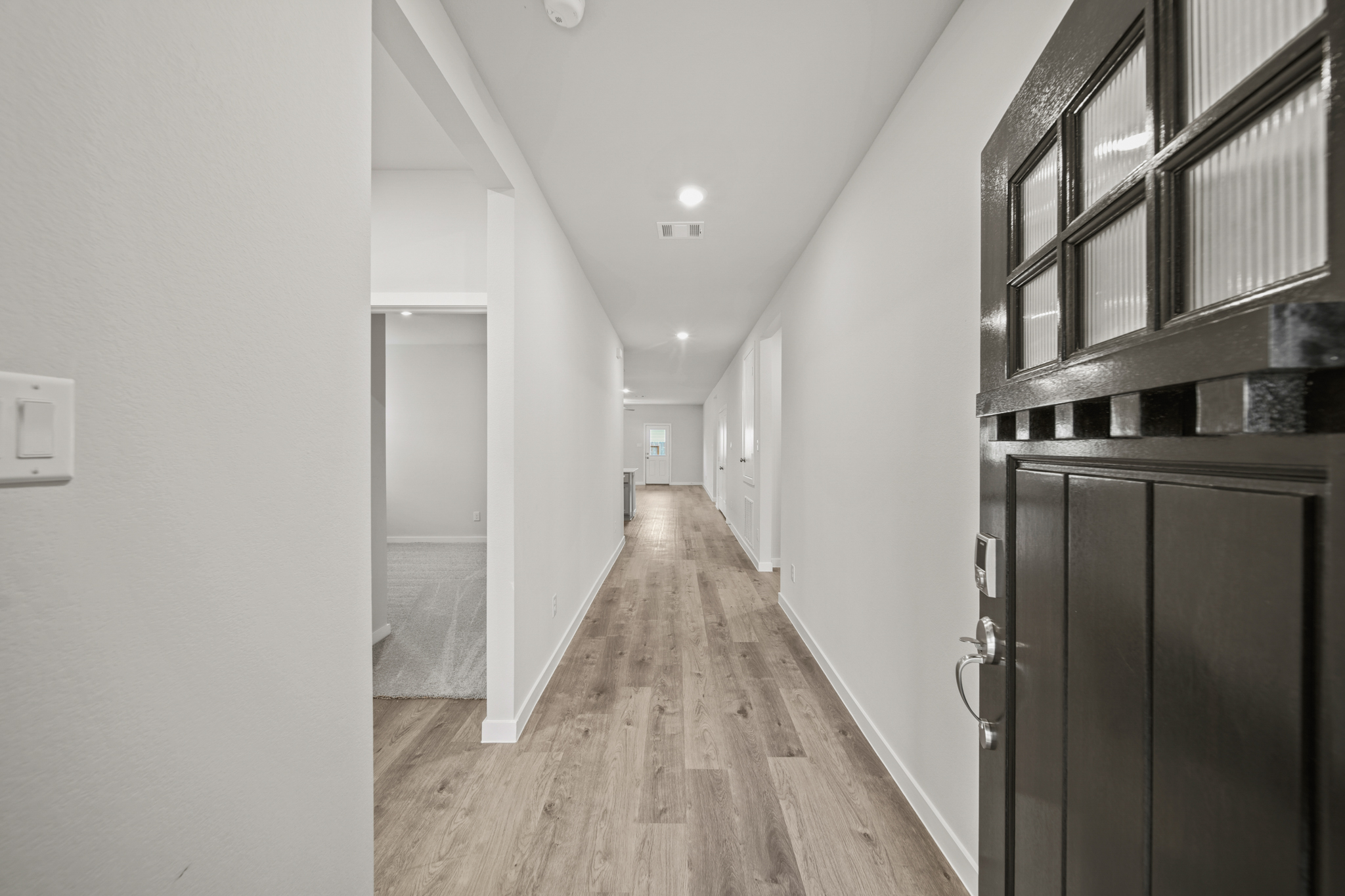 A hallway with black cabinets.