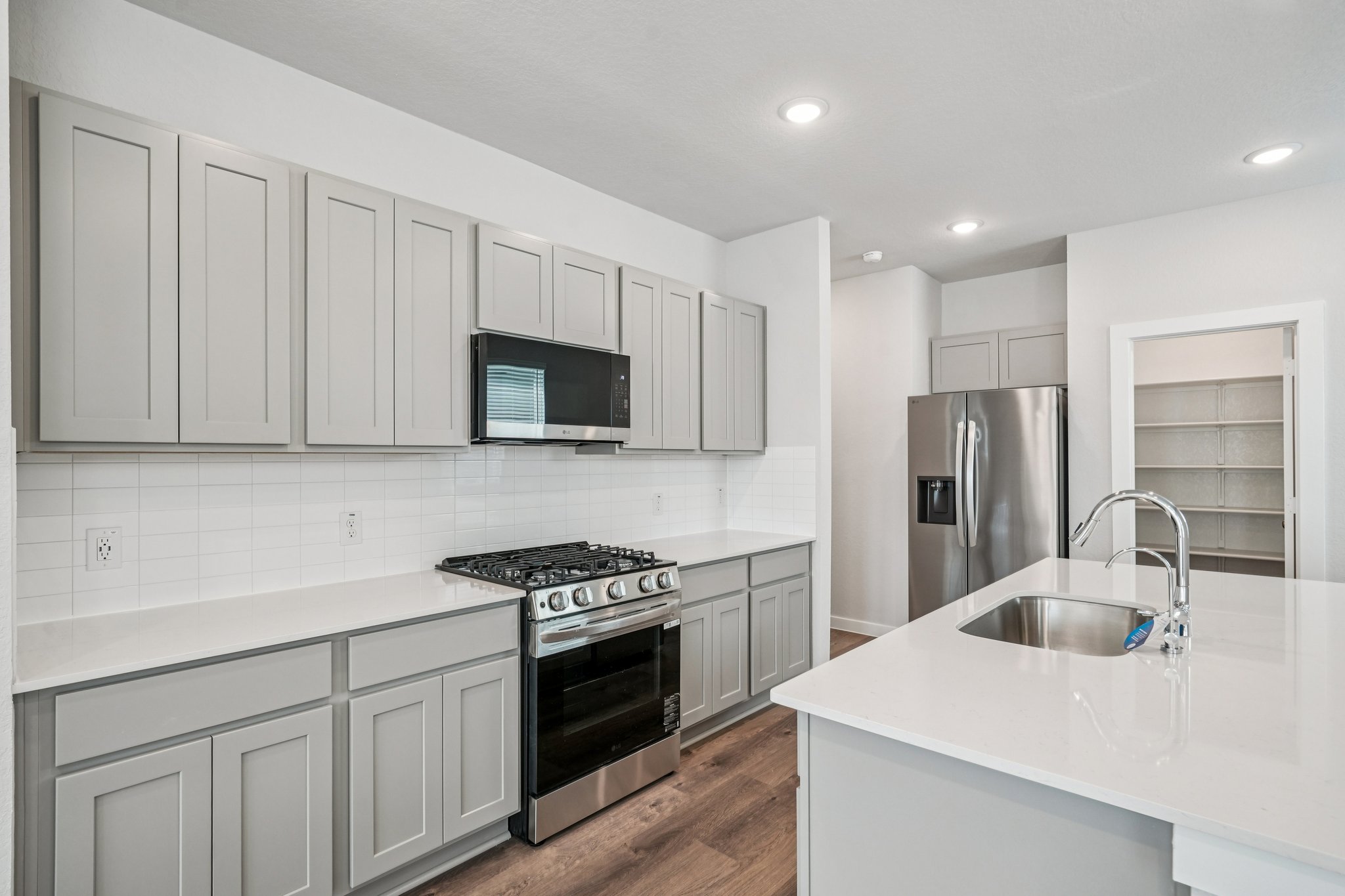A kitchen with white cabinets.