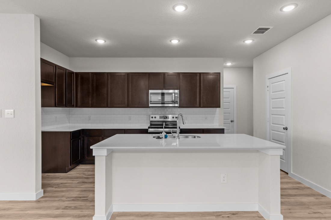 A kitchen with a white counter top.