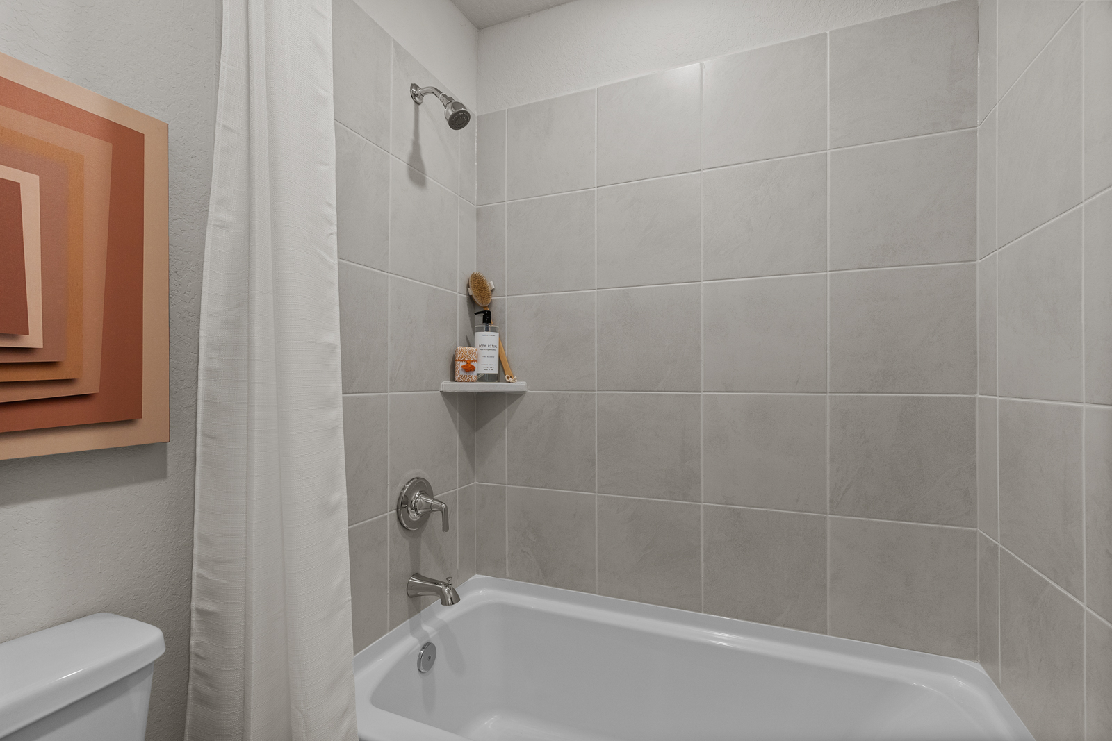 A bathroom with a bathtub and toilet.