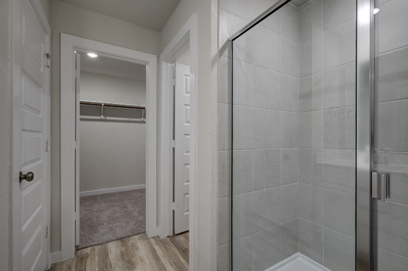 A shower with glass doors.