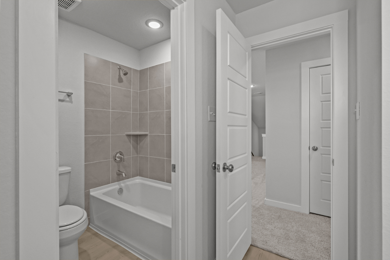 A bathroom with a tub toilet and sink.