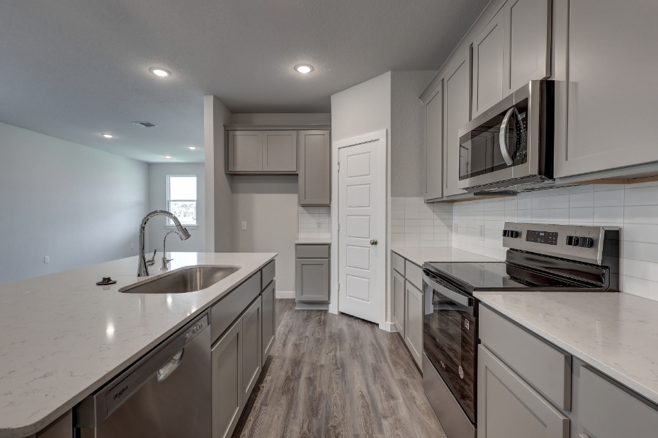 A kitchen with white cabinets.