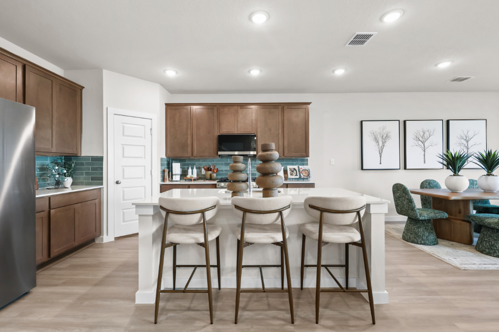 A kitchen with a table and chairs.