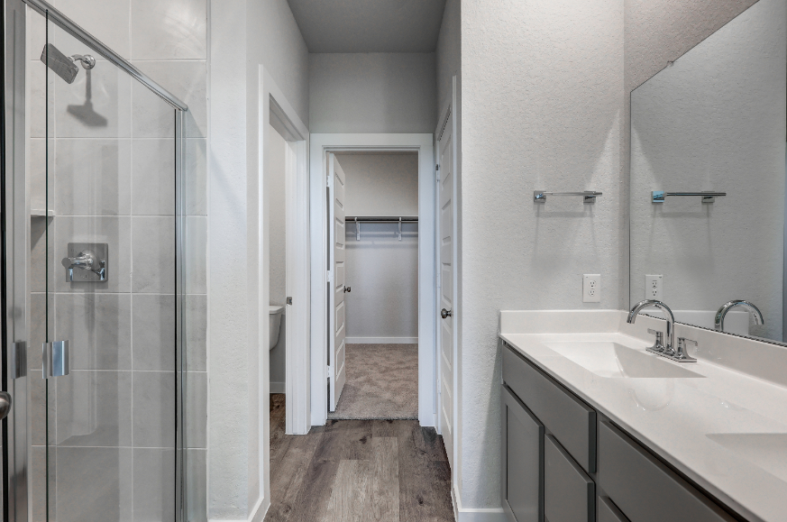 A bathroom with a sink and shower.