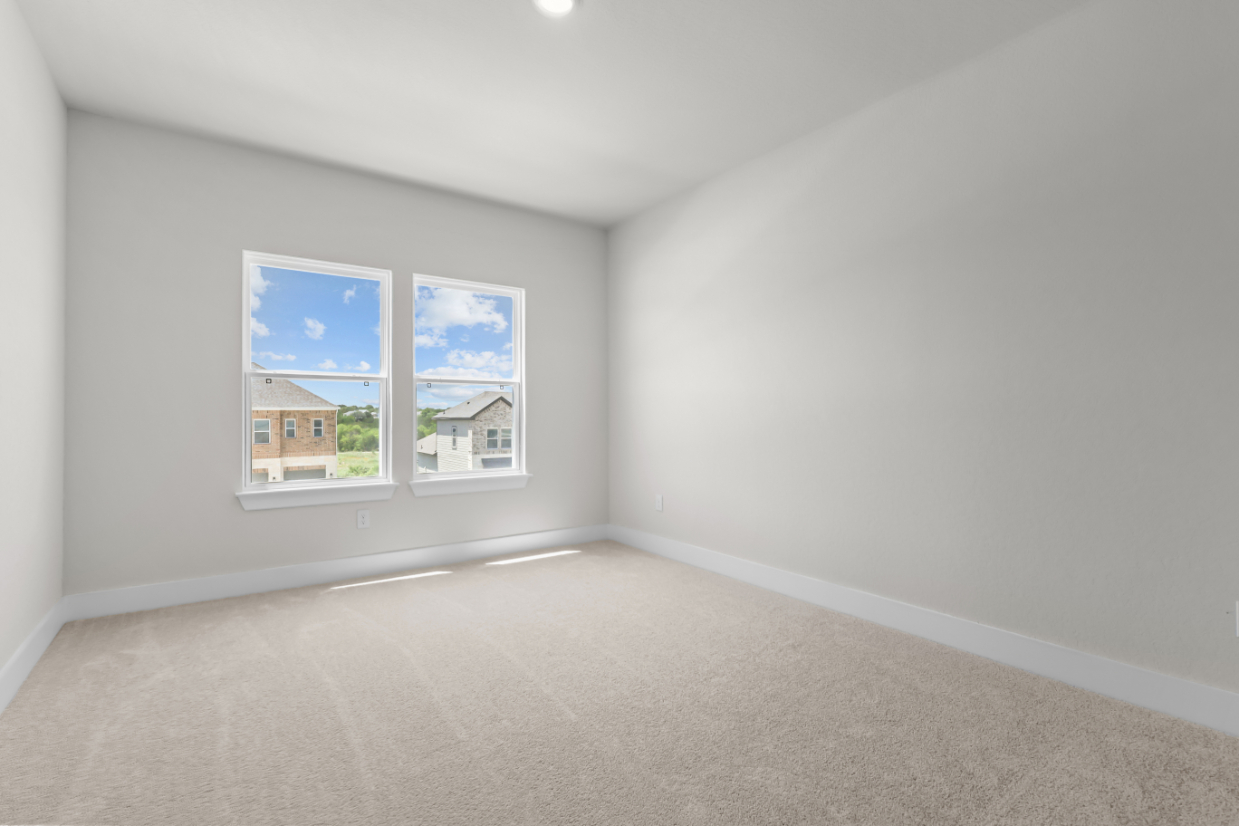 A room with a window and a carpet.