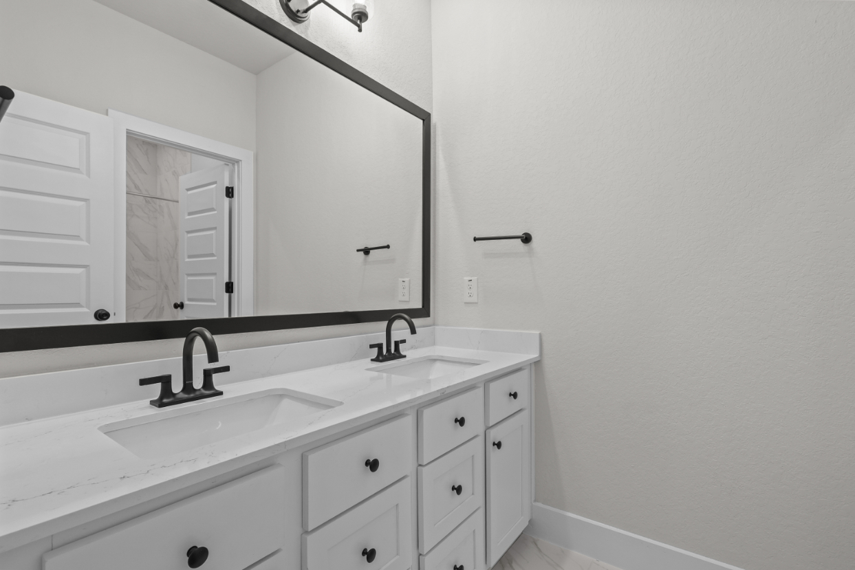 A bathroom with a large mirror.