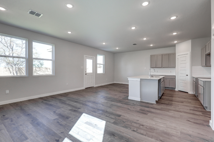A kitchen with white cabinets.