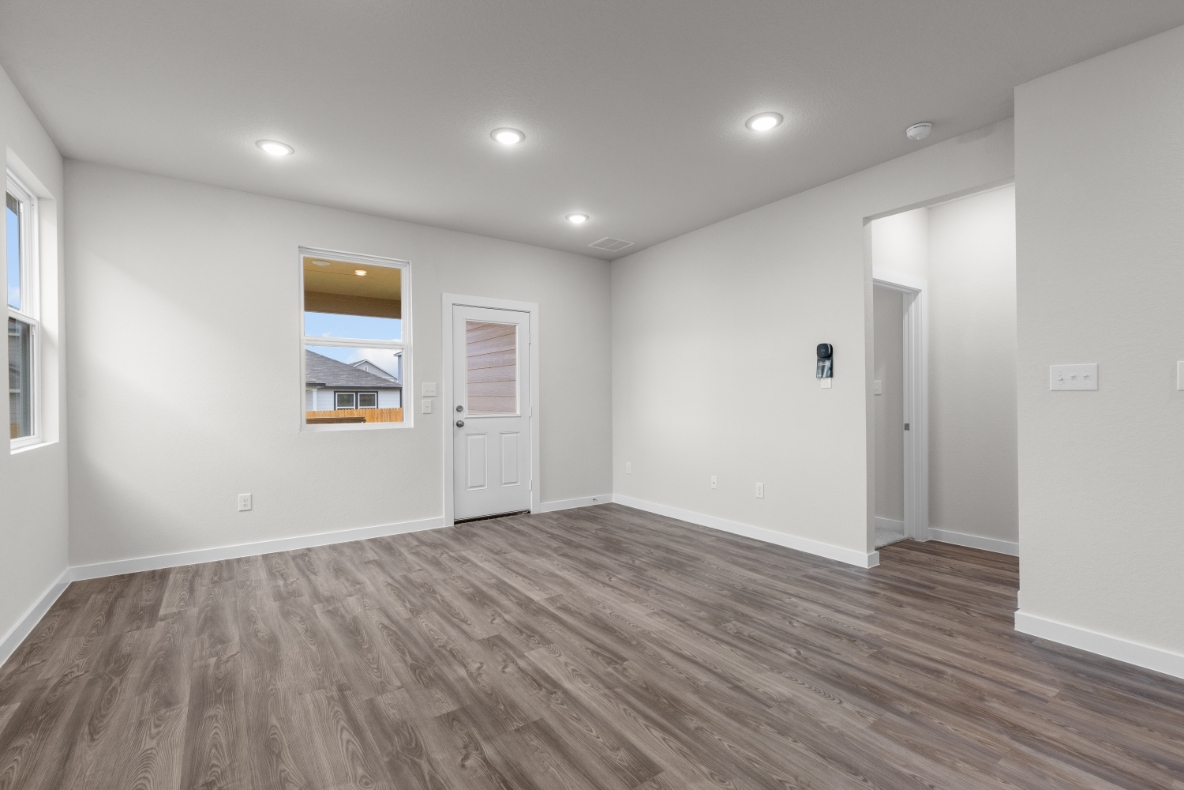 A room with white walls and a wood floor.