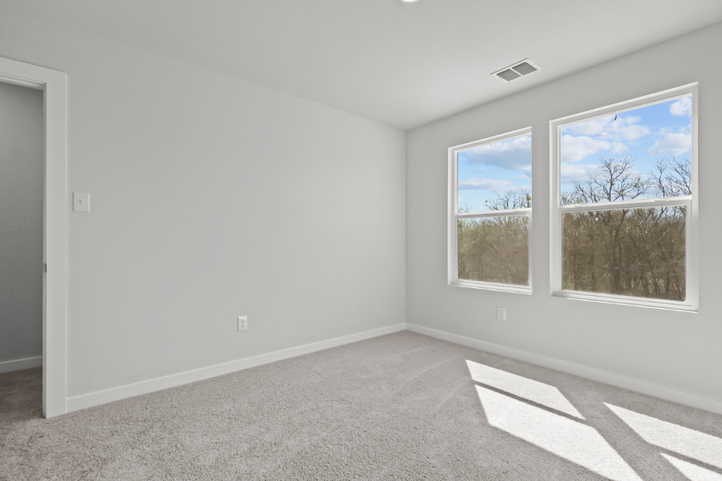 A room with a couple of windows.