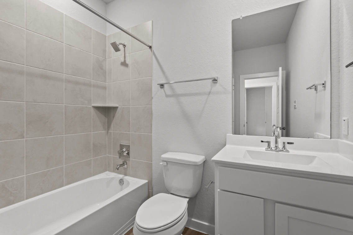 A bathroom with a toilet sink and bathtub.