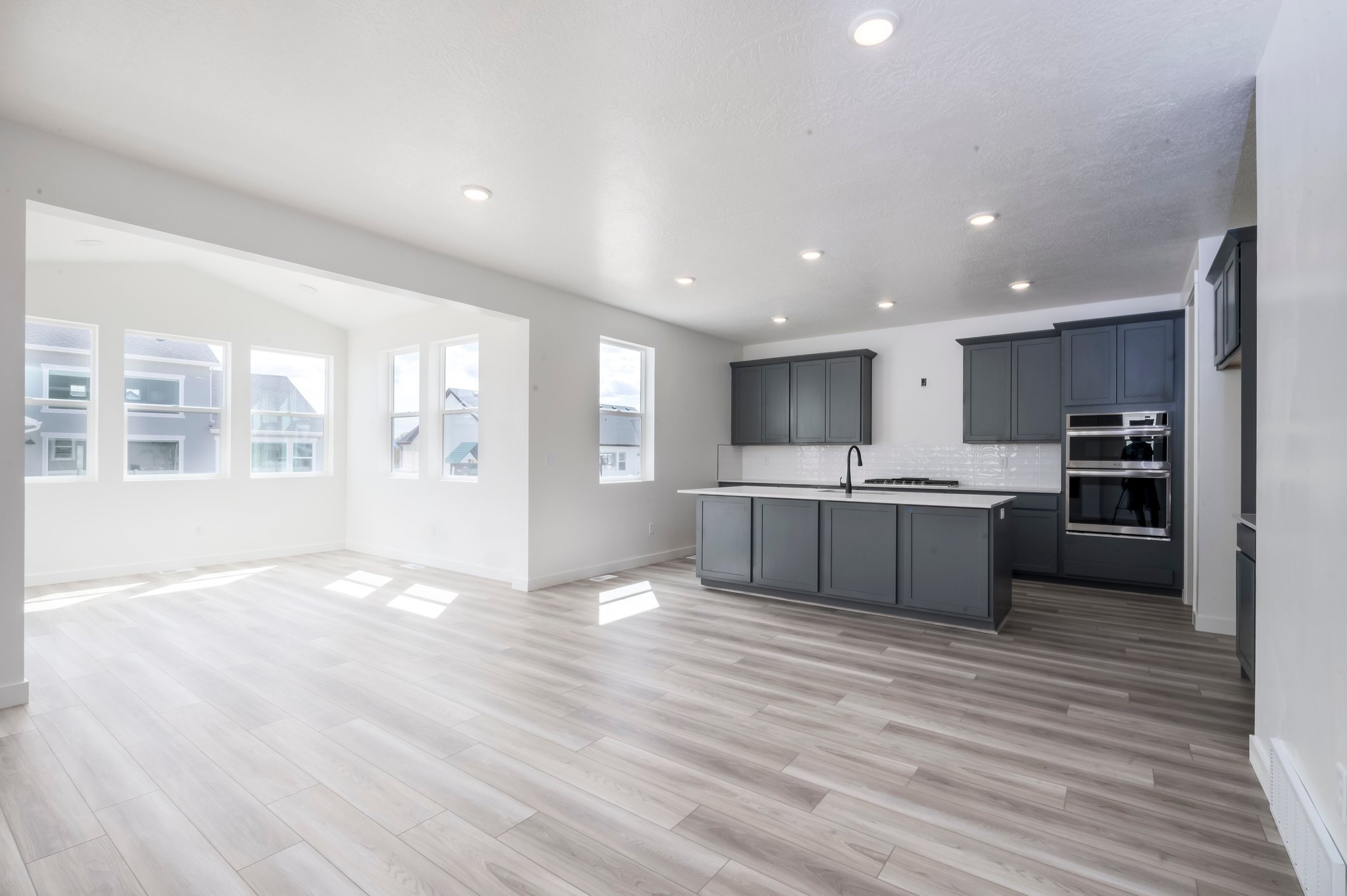 A large kitchen with black cabinets.