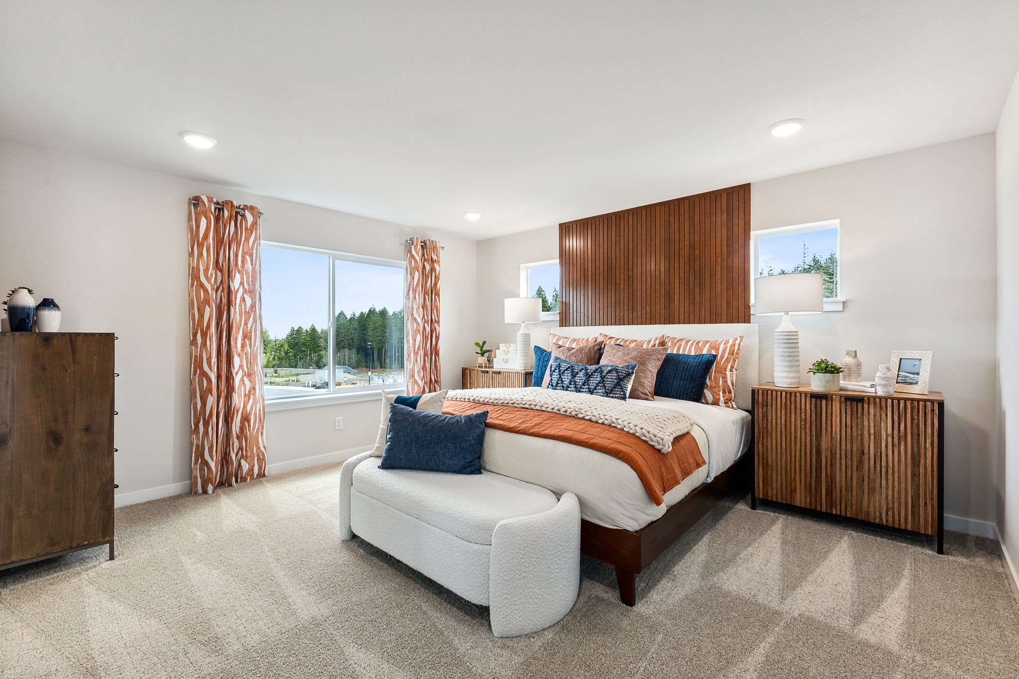 A large bedroom with a large window.