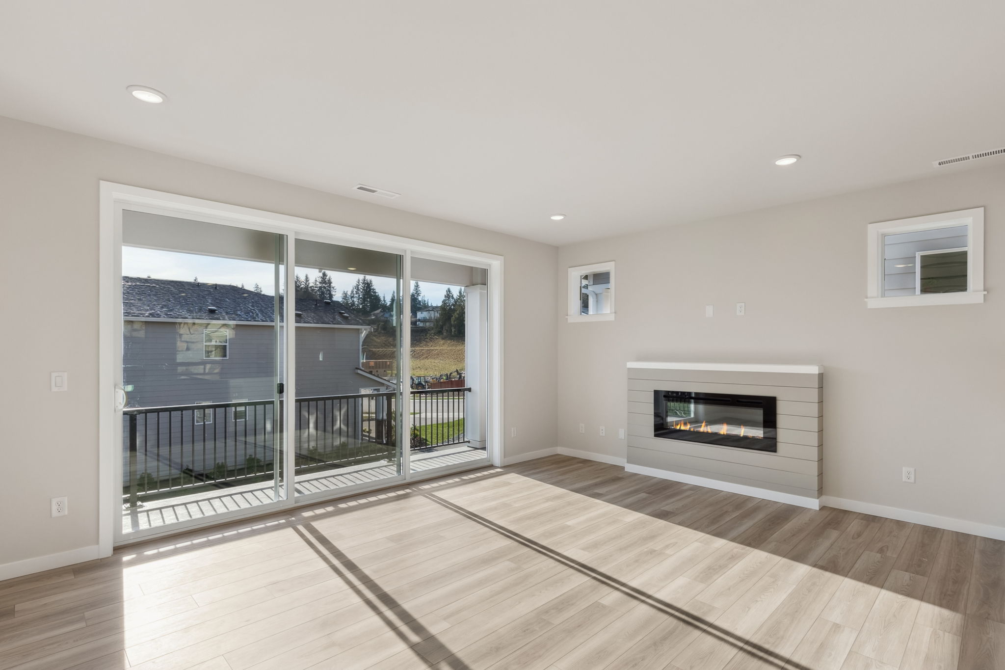 A room with a fireplace and a wood floor.