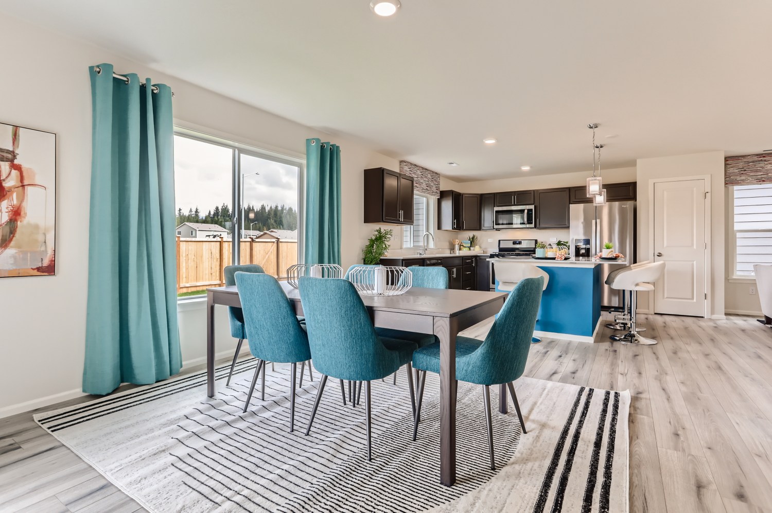 A dining room with a table and chairs.