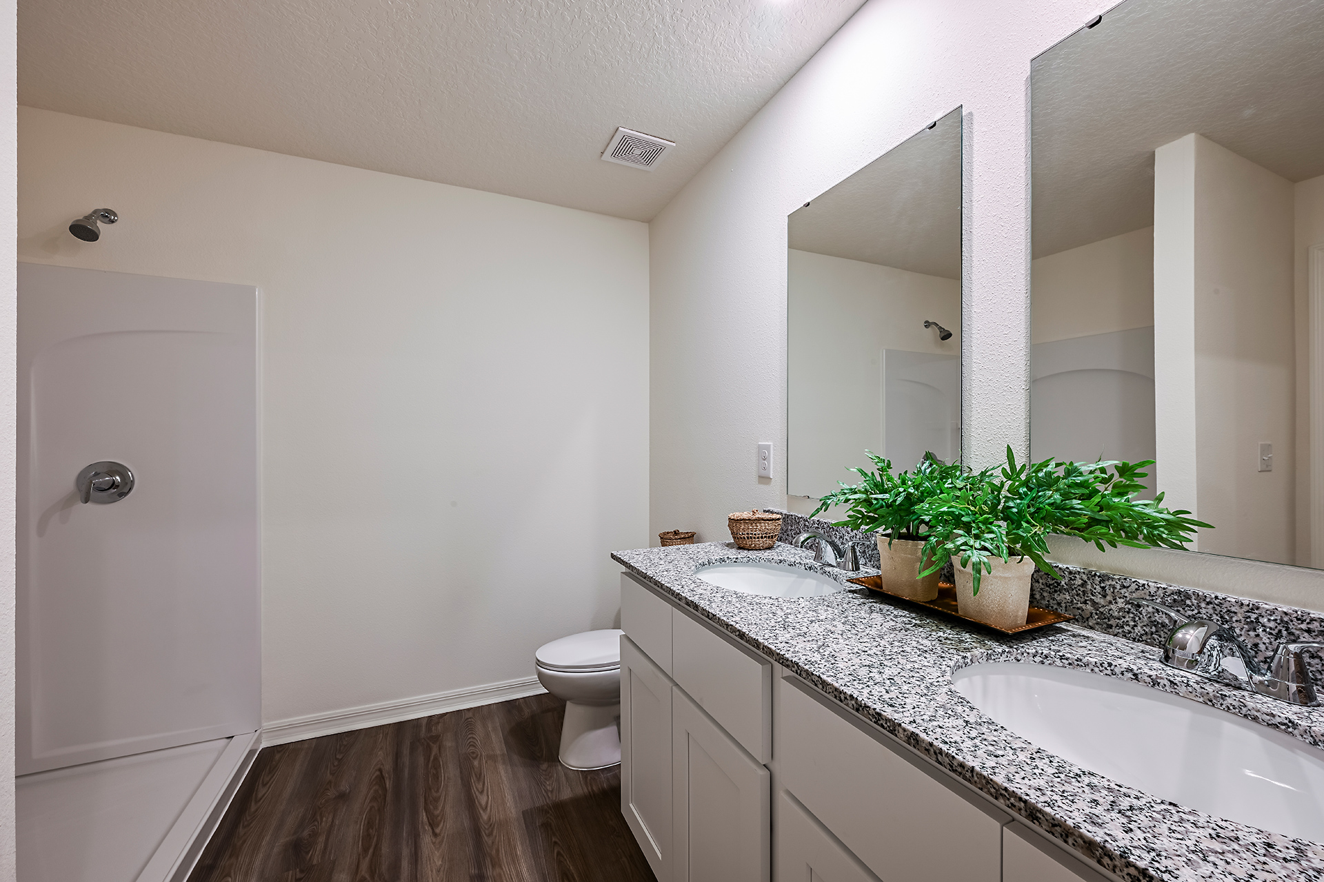 A bathroom with a large mirror.