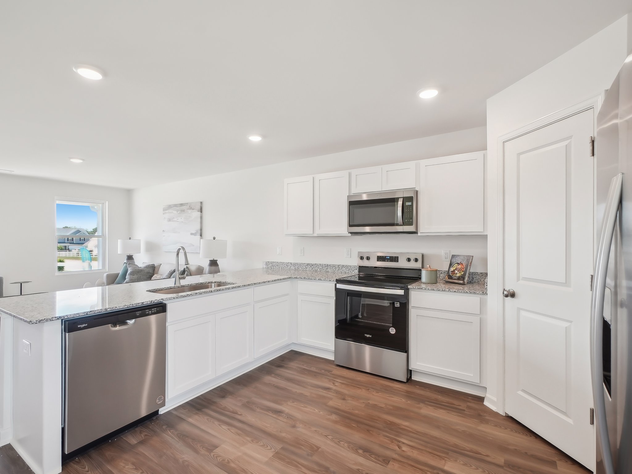 A kitchen with white cabinets.