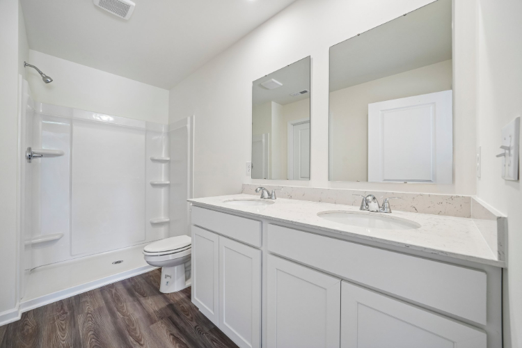 A bathroom with a toilet and sink.