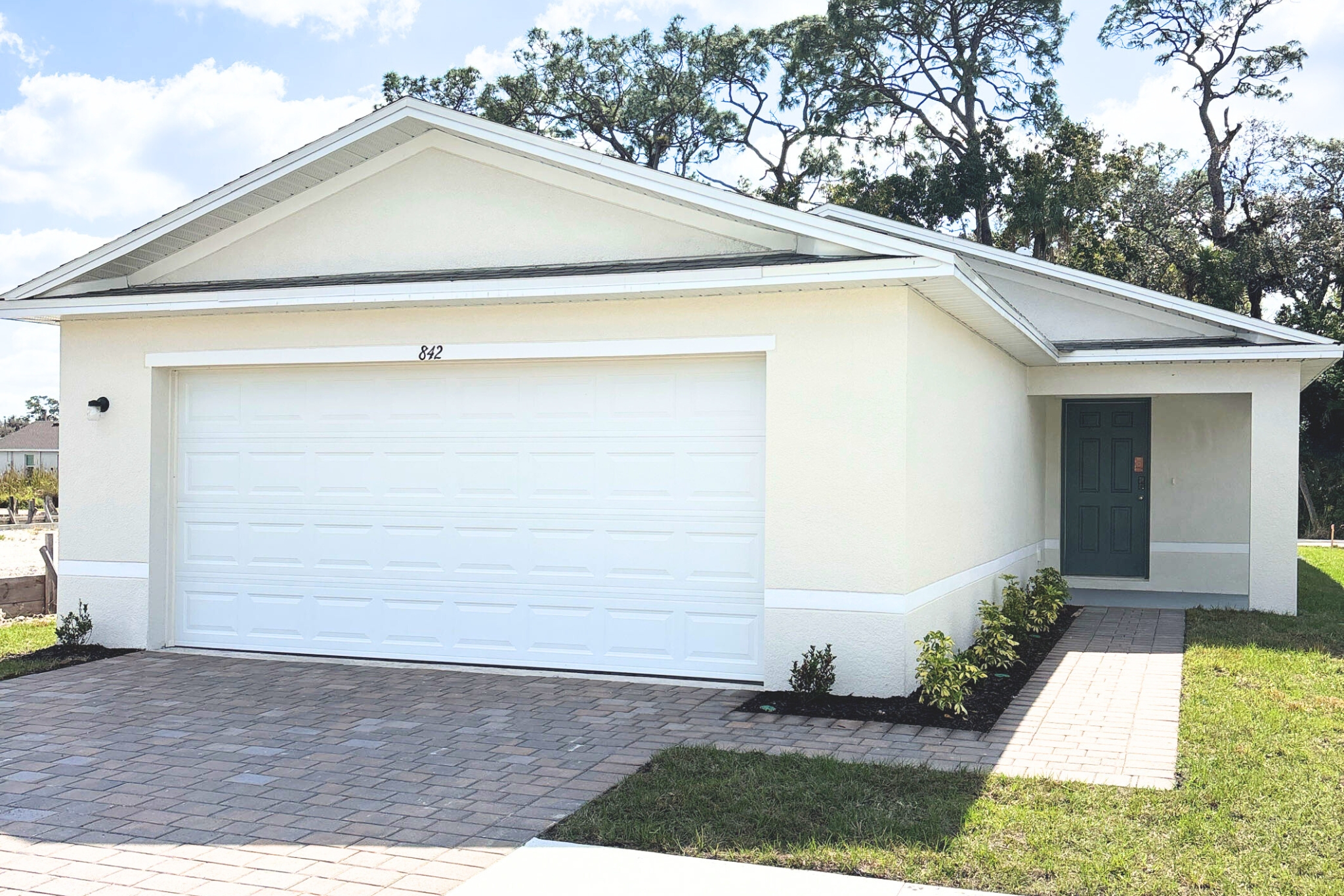 A white garage with a door.