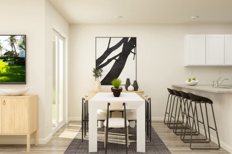 A kitchen with a table and chairs.