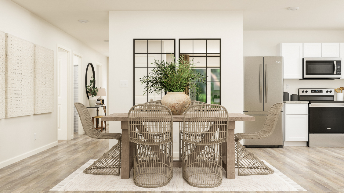 A dining room with a table and chairs.