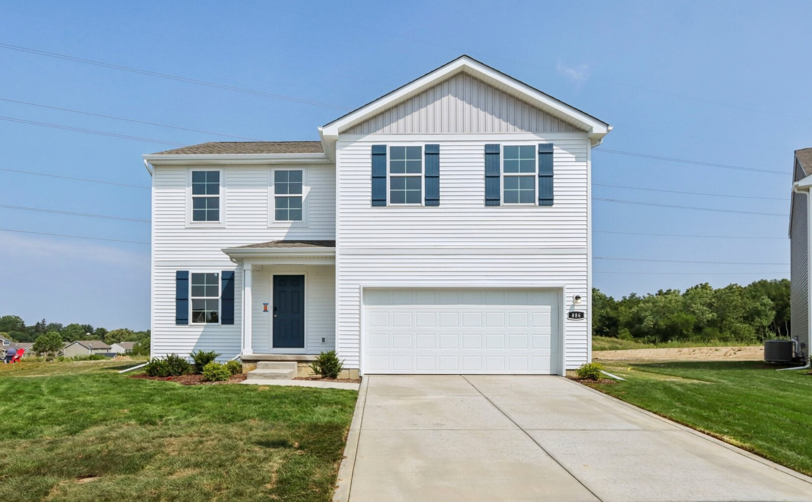 A white house with a garage.