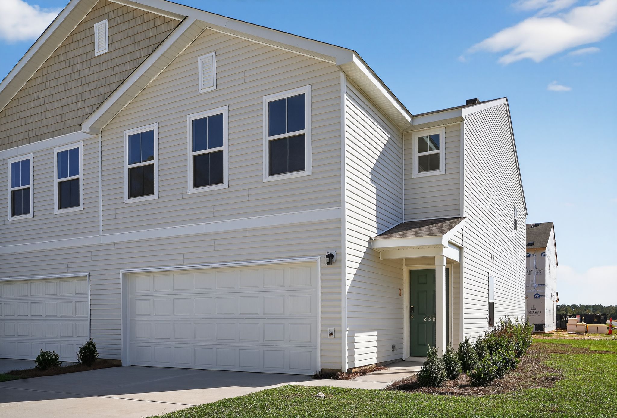 A white house with a garage.