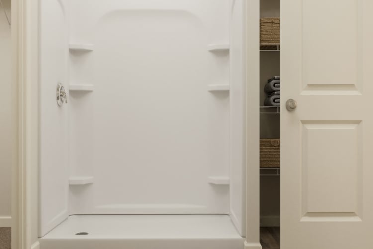 A white bathtub in a bathroom.